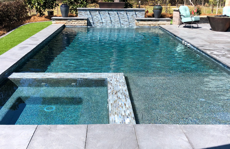 Pool with scupper water feature installation.