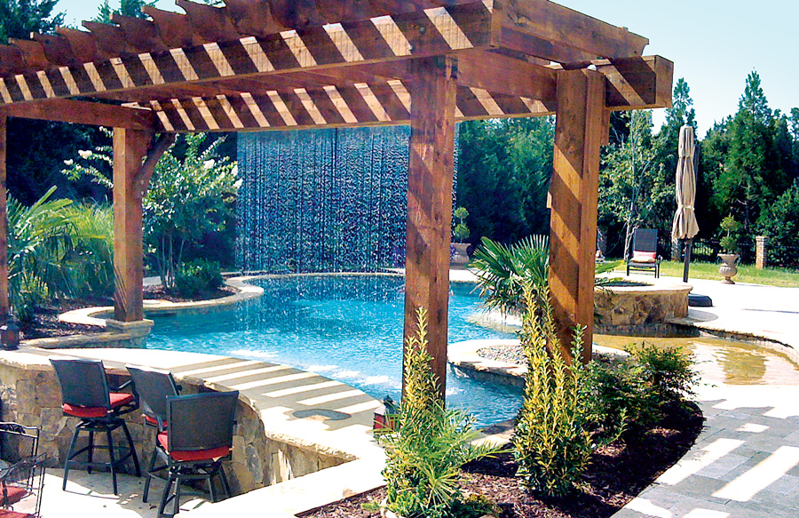 Pergola with teardrop rain-curtain-style water feature on pool.